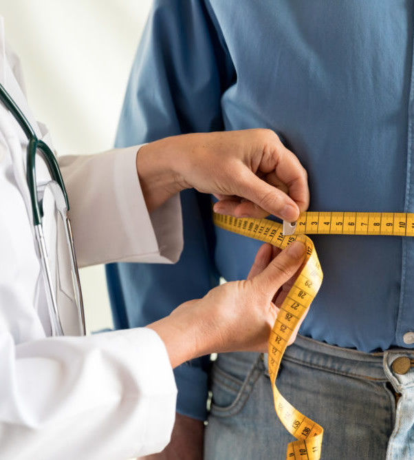 Medical Weight Loss Therapy - photo of doctor measuring patients waste